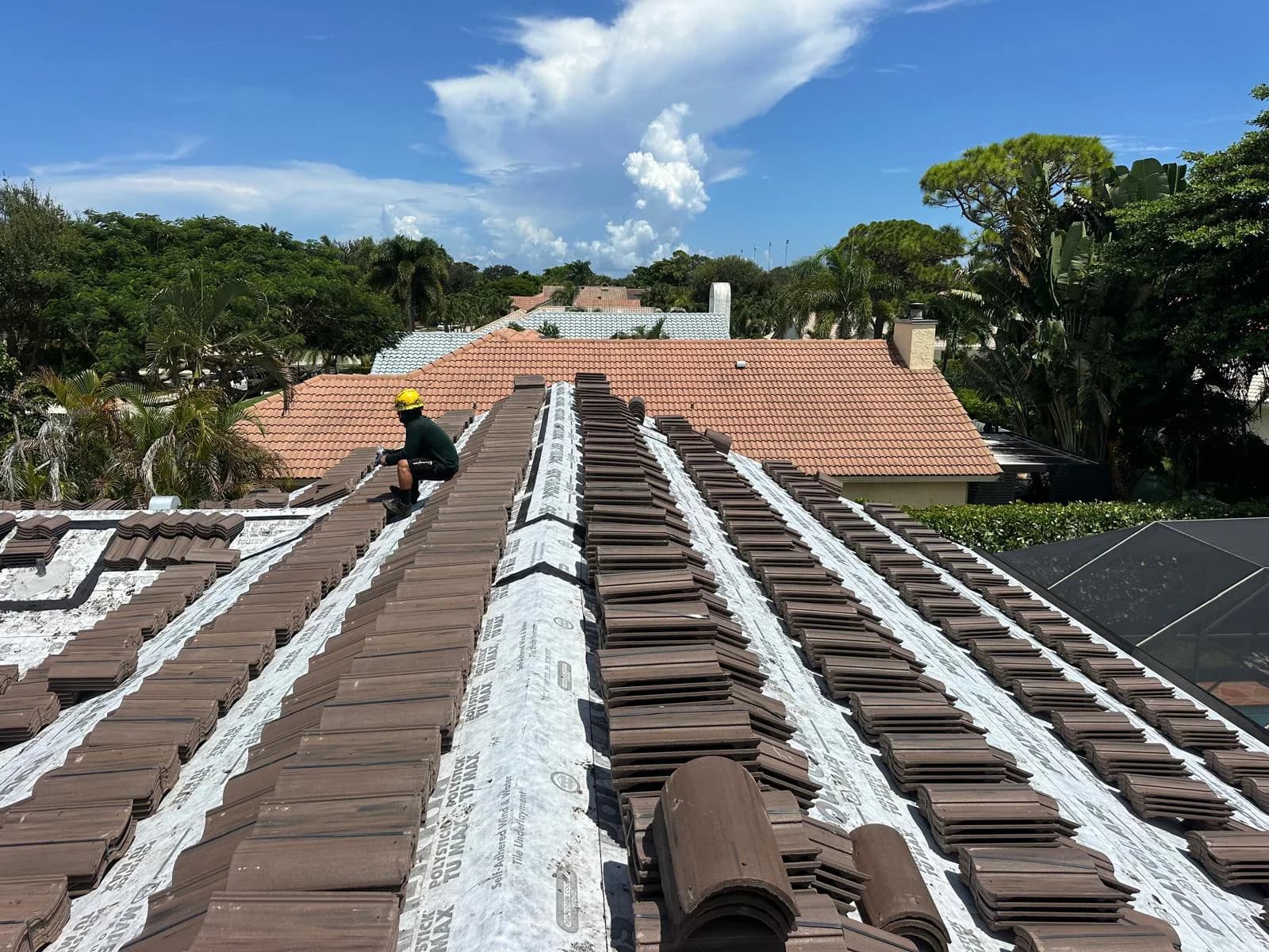 Chestnut Burnt Barcelona 900 tile bundles distributed across multiple roof planes at a Boca Raton-area project