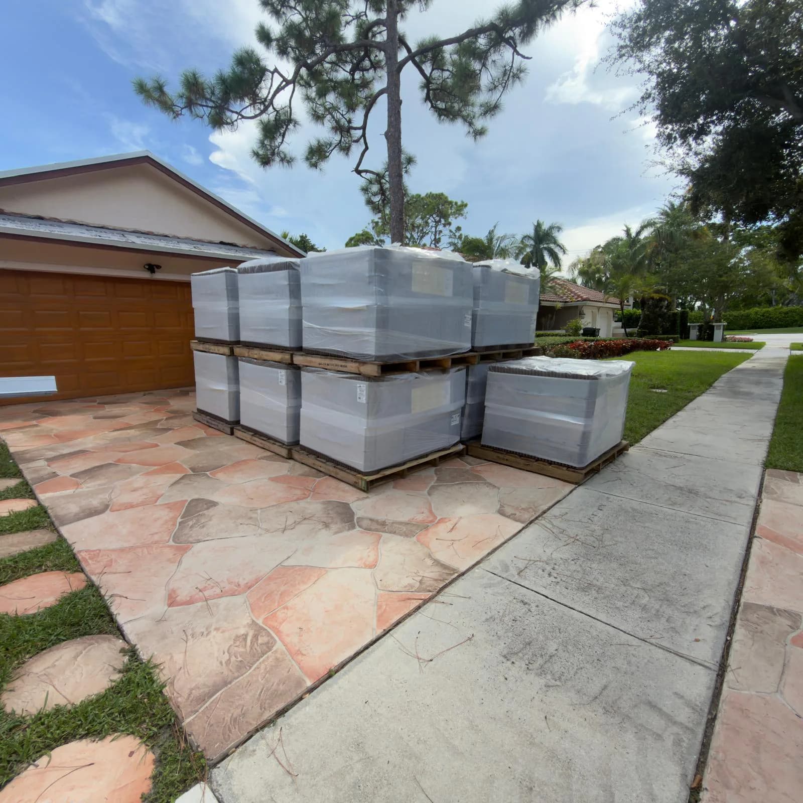 Wrapped Barcelona 900 roof tile pallets staged at a Boca Raton-area jobsite