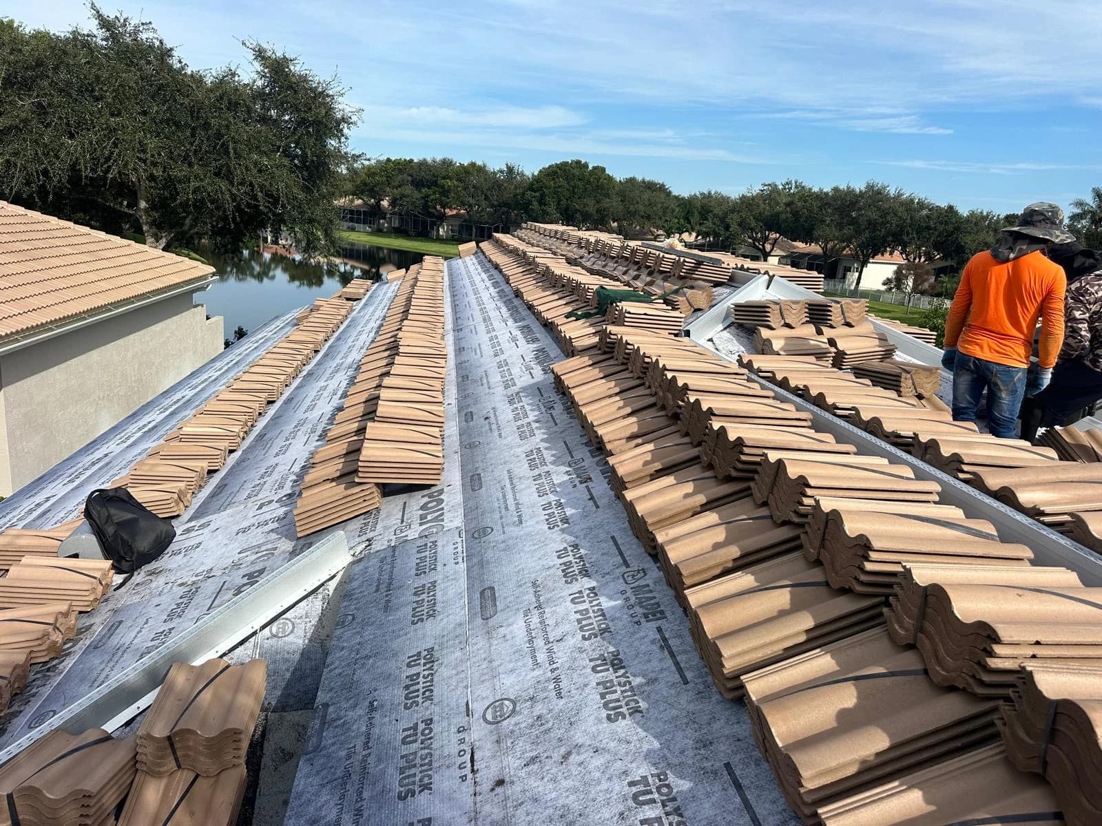 Estate roof tile bundles staged across prepared roof sections in the Delray Beach area