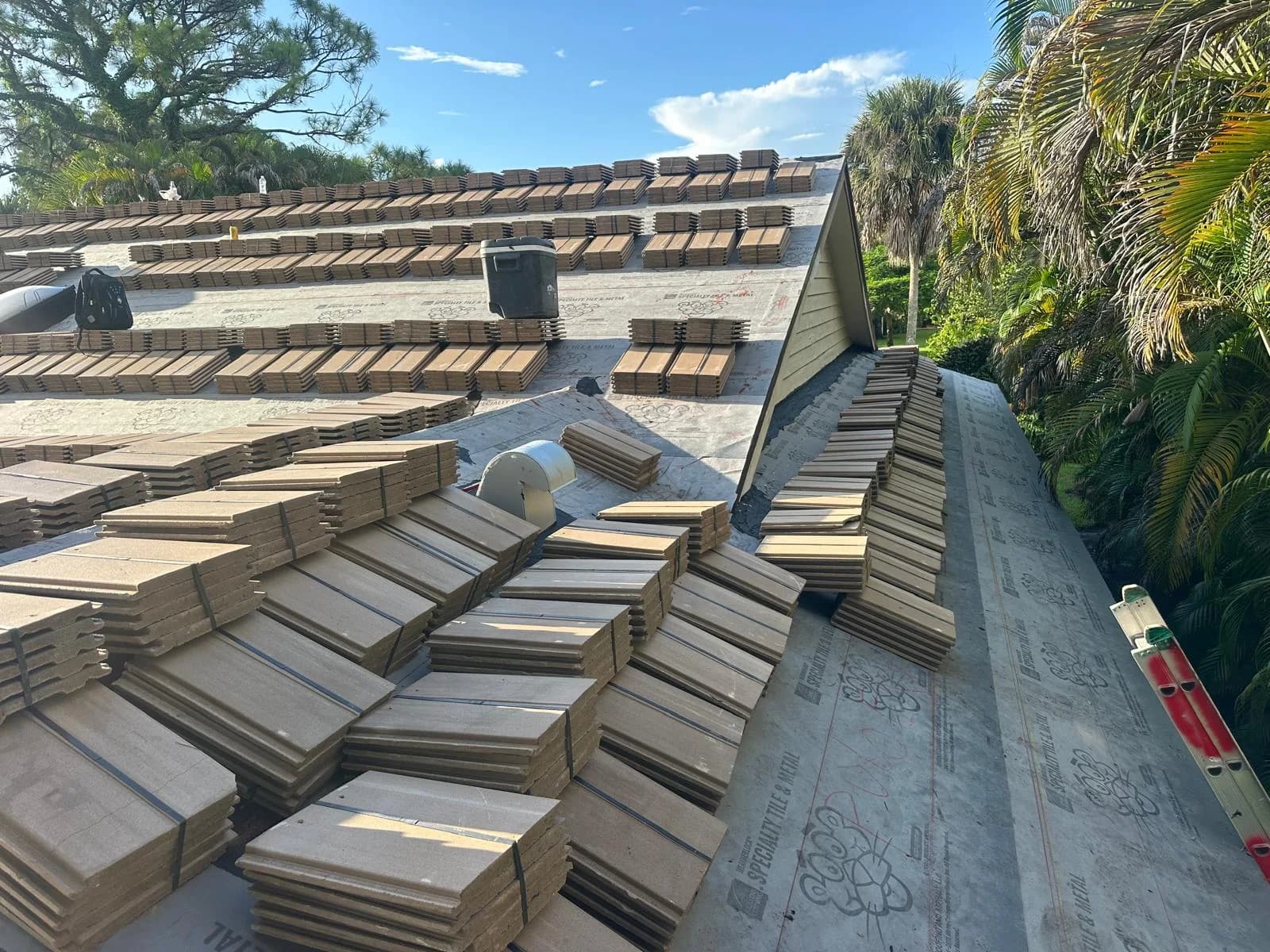 Saxony 900 Split Slate concrete roof tile bundles staged across a Jupiter-area roof after loading