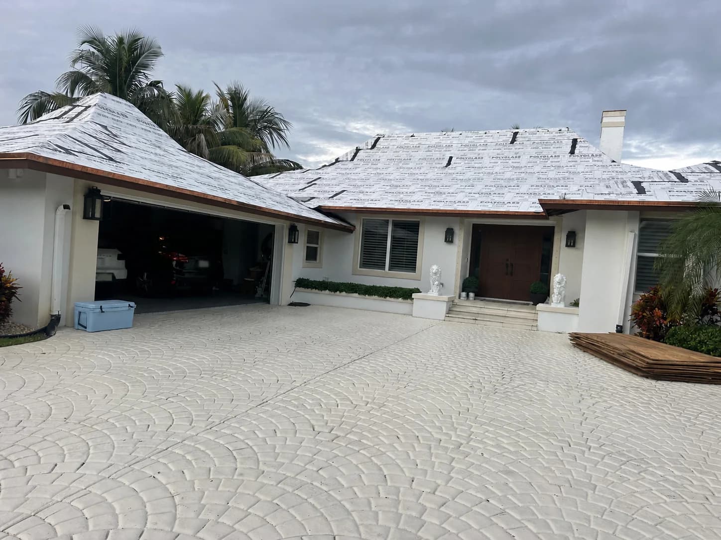 Prepared multi-plane roof and protected driveway before Madera 900 rooftop loading in North Palm Beach