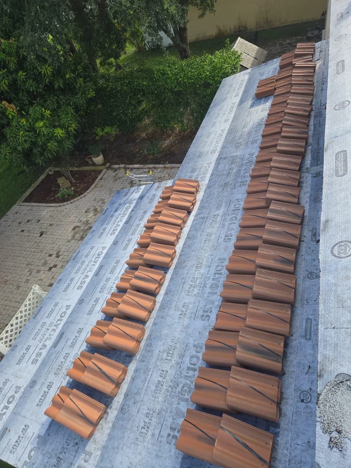 Villa 900 tile bundles hand-staged on the separate rear roof section at a West Palm Beach-area home