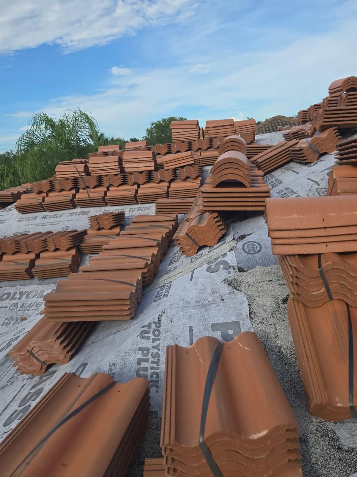 Villa 900 concrete roof tile bundles organized across the primary roof at a West Palm Beach-area project