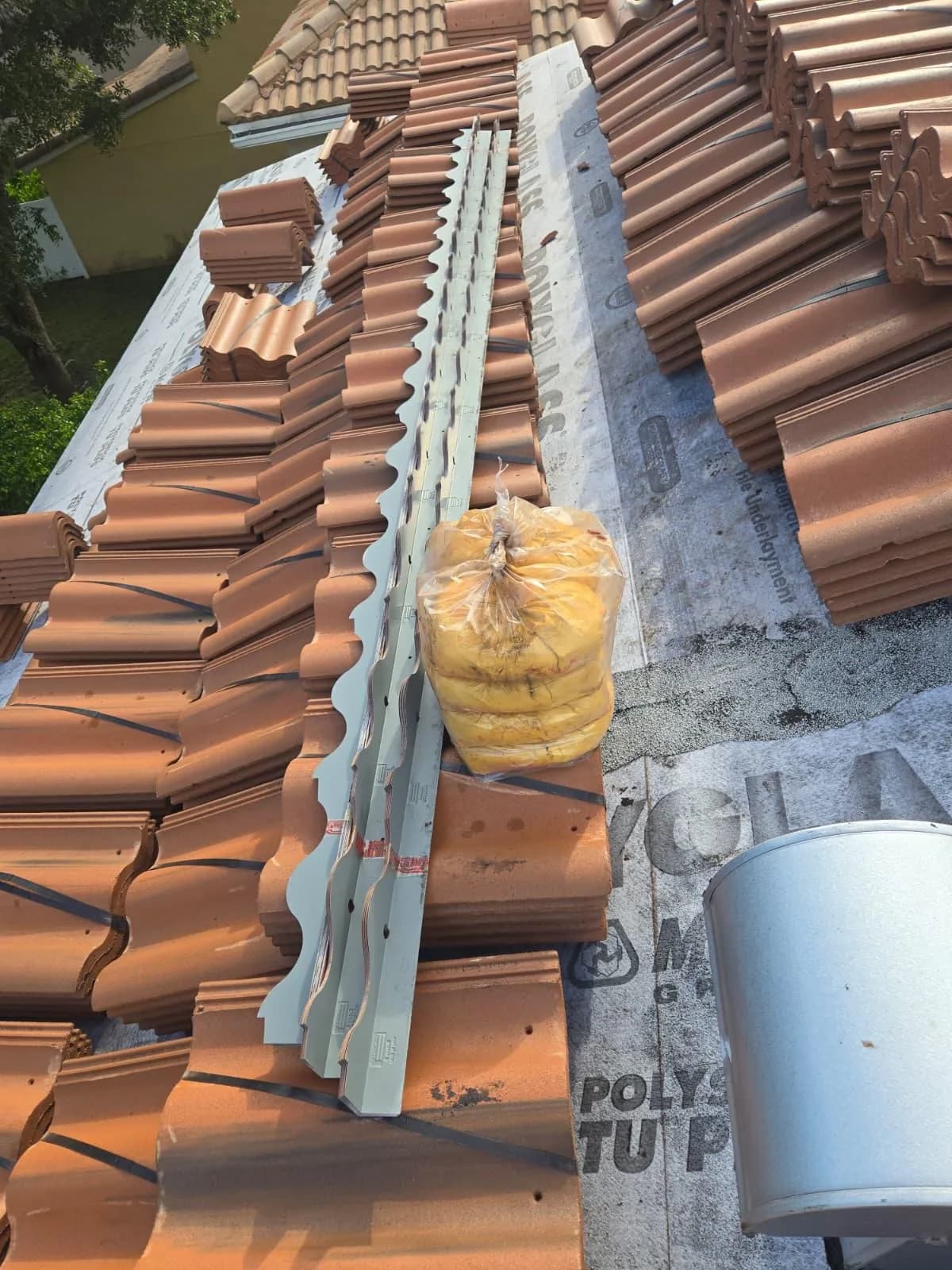 Villa 900 concrete roof tile and metal roof components staged for installation