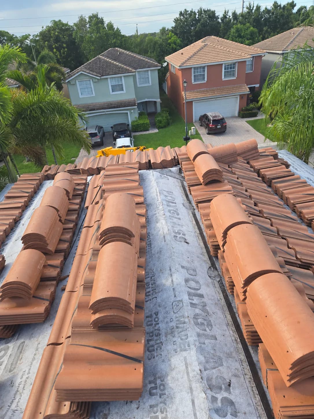 Villa 900 concrete roof tile bundles staged across a West Palm Beach-area roof during loading
