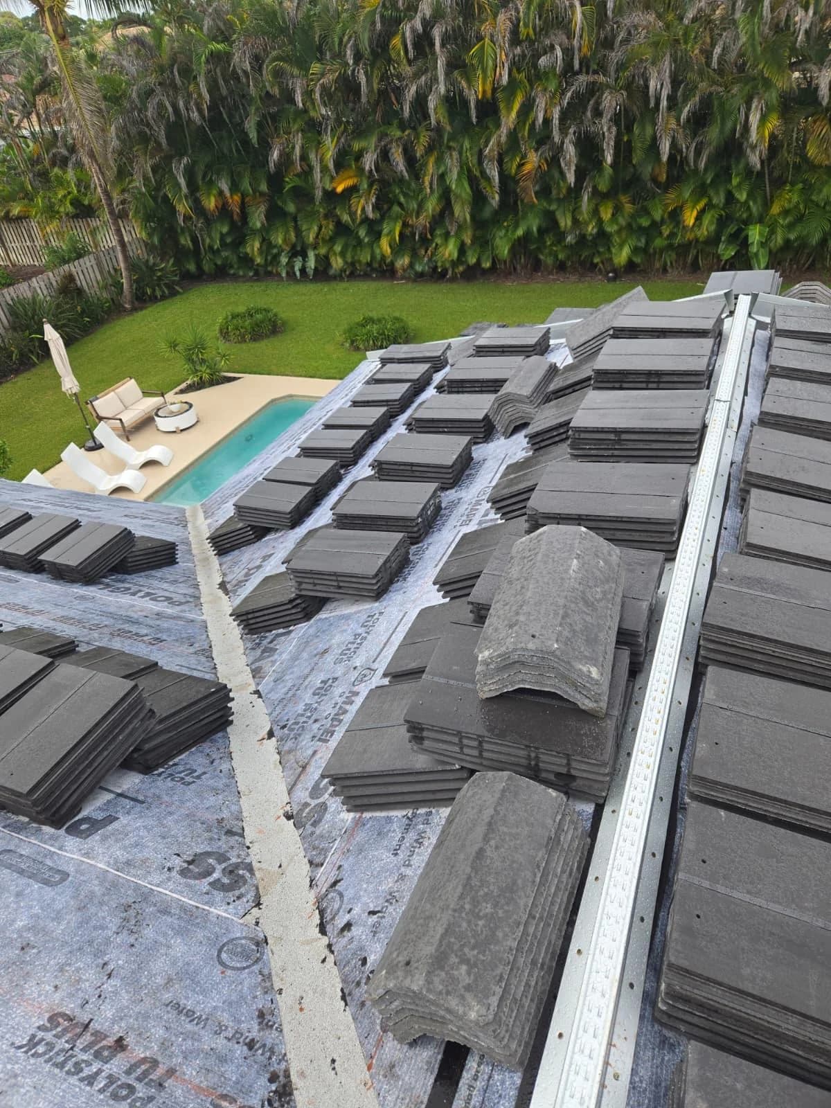 Saxony 900 field and ridge tile staged on a rear roof plane near a pool