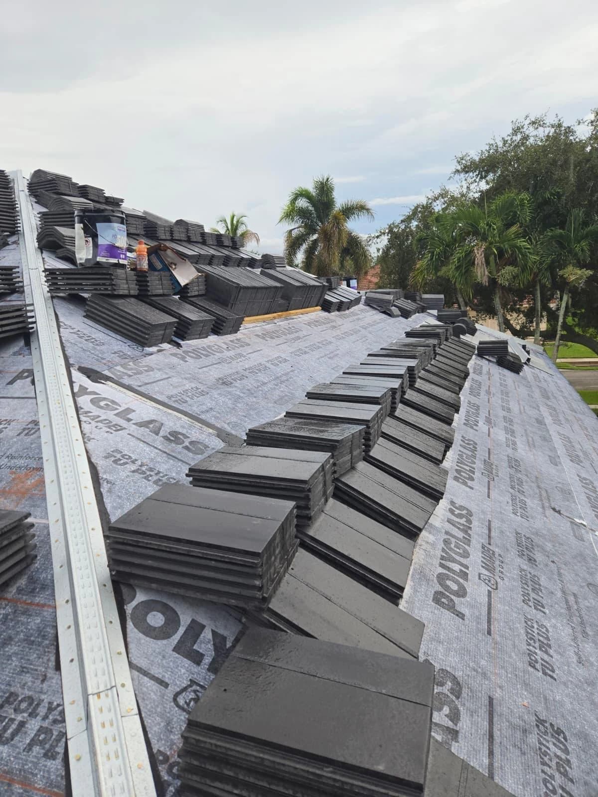 Slate Black Antique concrete tile organized in rows on a prepared Jupiter roof
