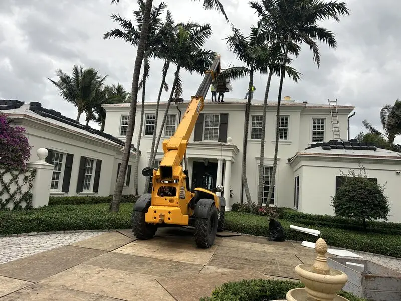 Telehandler placing roof tile for a Florida roofing crew