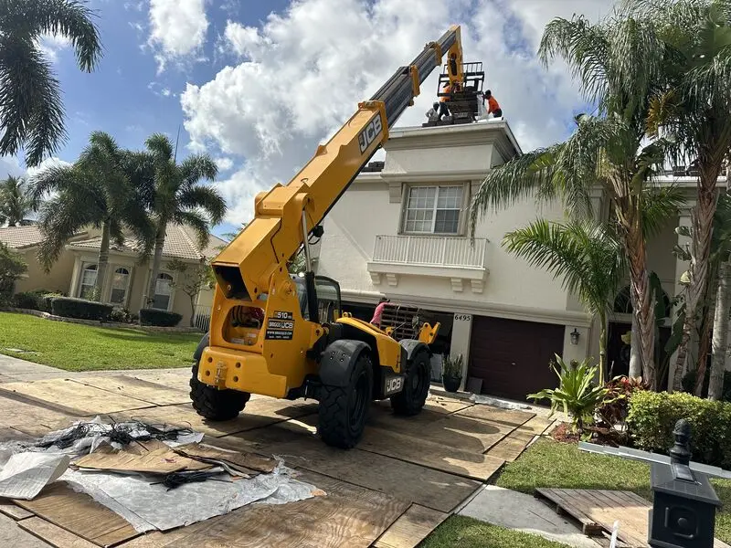 MMJ telehandler loading roof tile at a South Florida residence