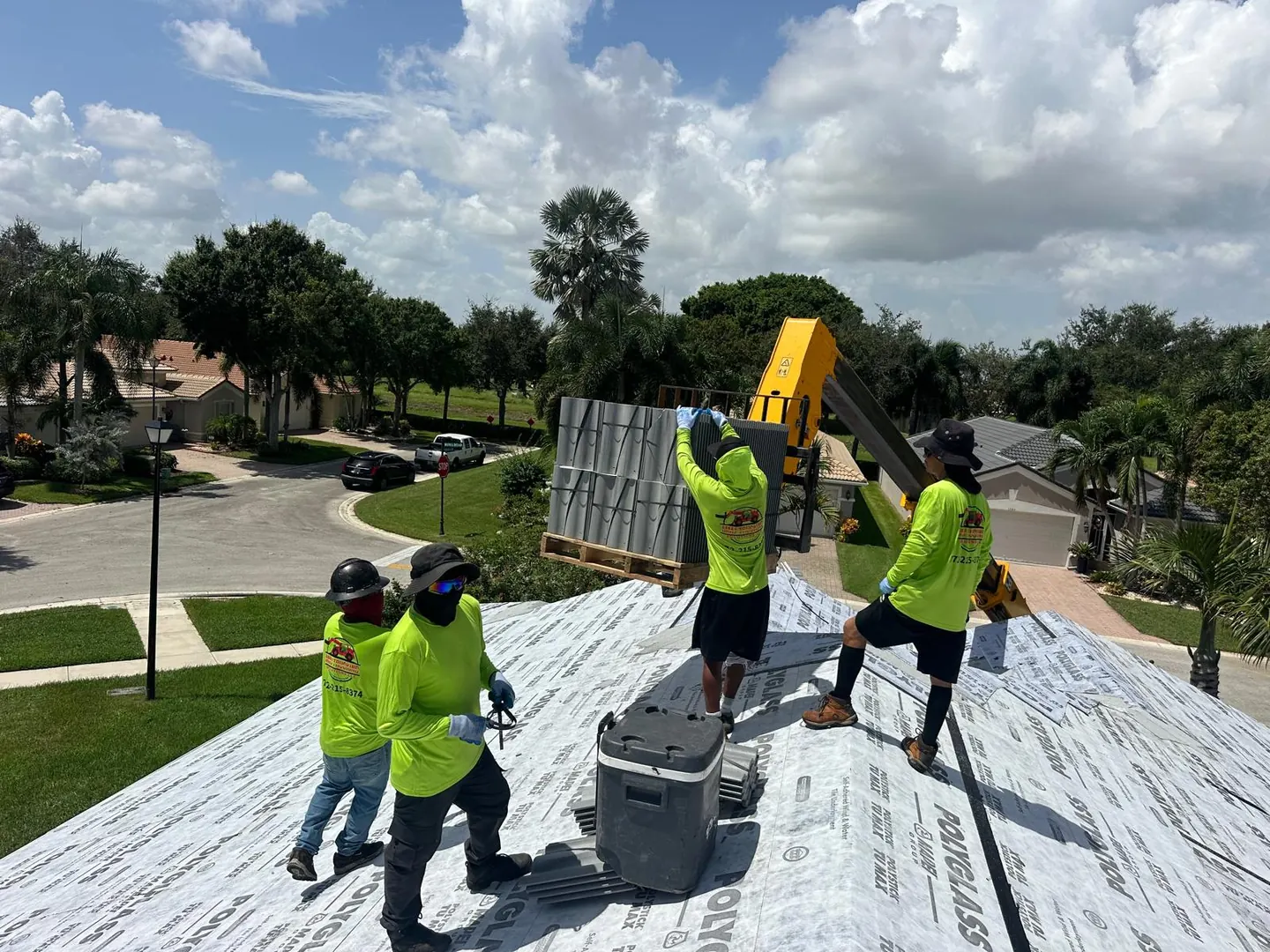 MMJ telehandler and wrapped roof tile pallets ready for a scheduled rooftop loading