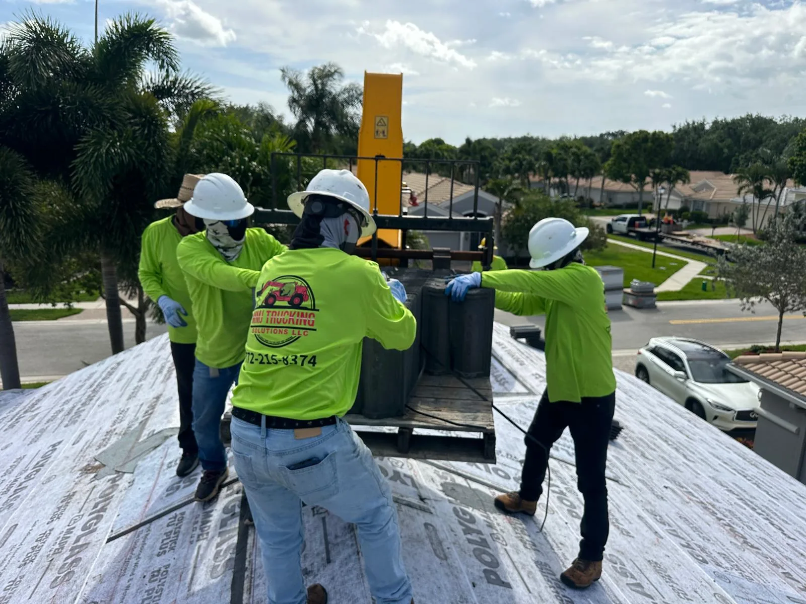 MMJ telehandler placing roof tile on a Florida home